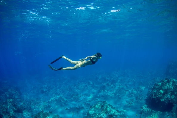 A woman exploring under water