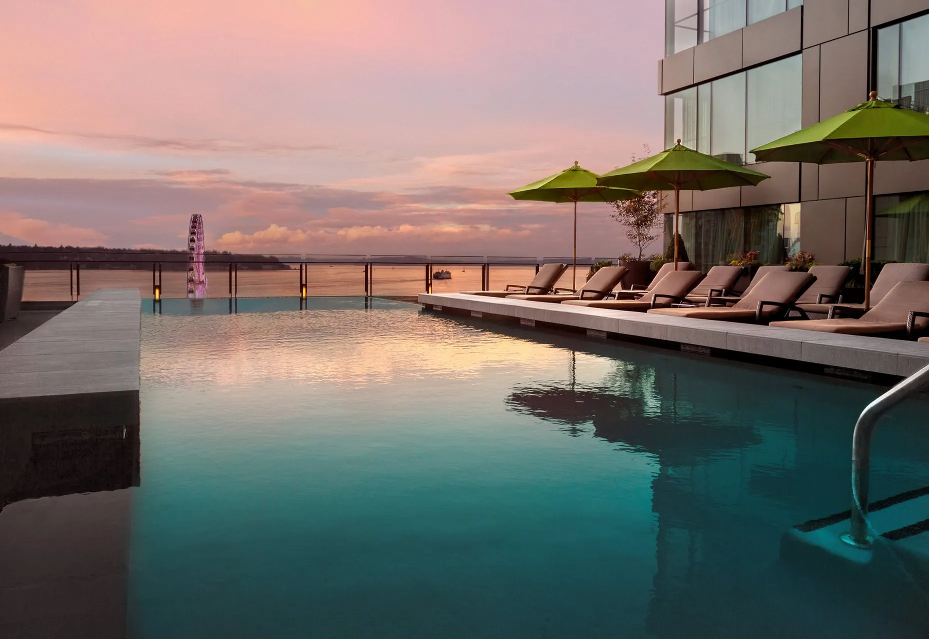The rooftop infinity swimming pool at dusk.