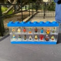 Minifigures in a case at a LEGOLAND California trading station.