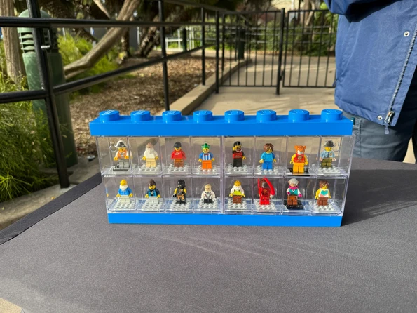 Minifigures in a case at a LEGOLAND California trading station.