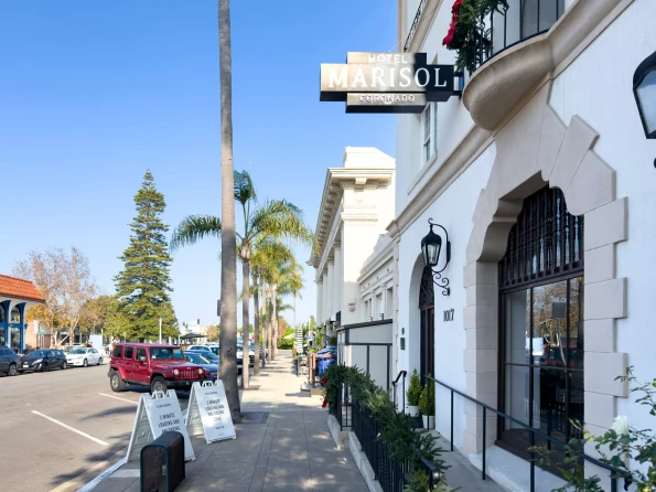 The Hotel Marisol Coronado sign and entrance on a sunny day.