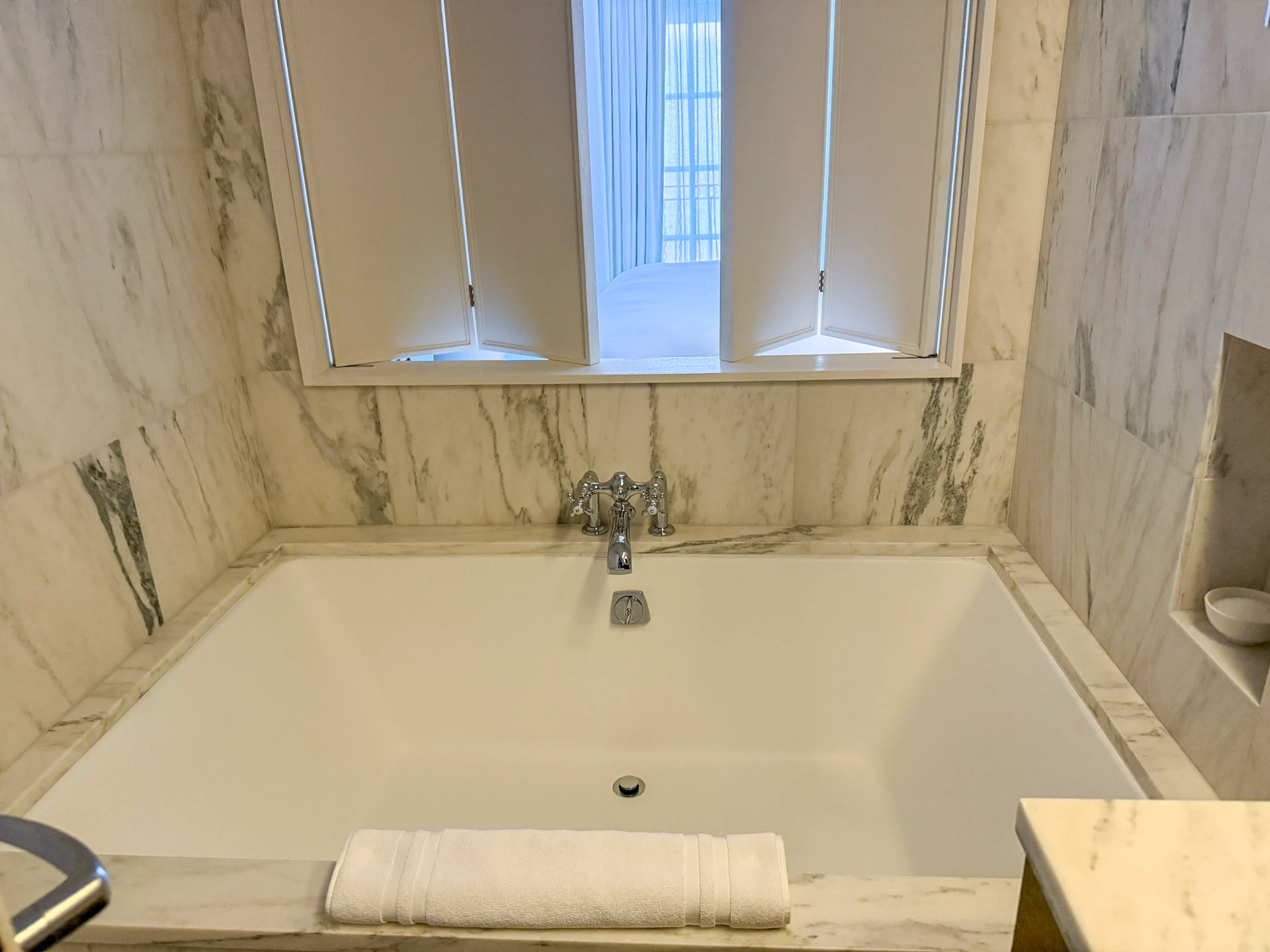 The very large bathtub and shutters.