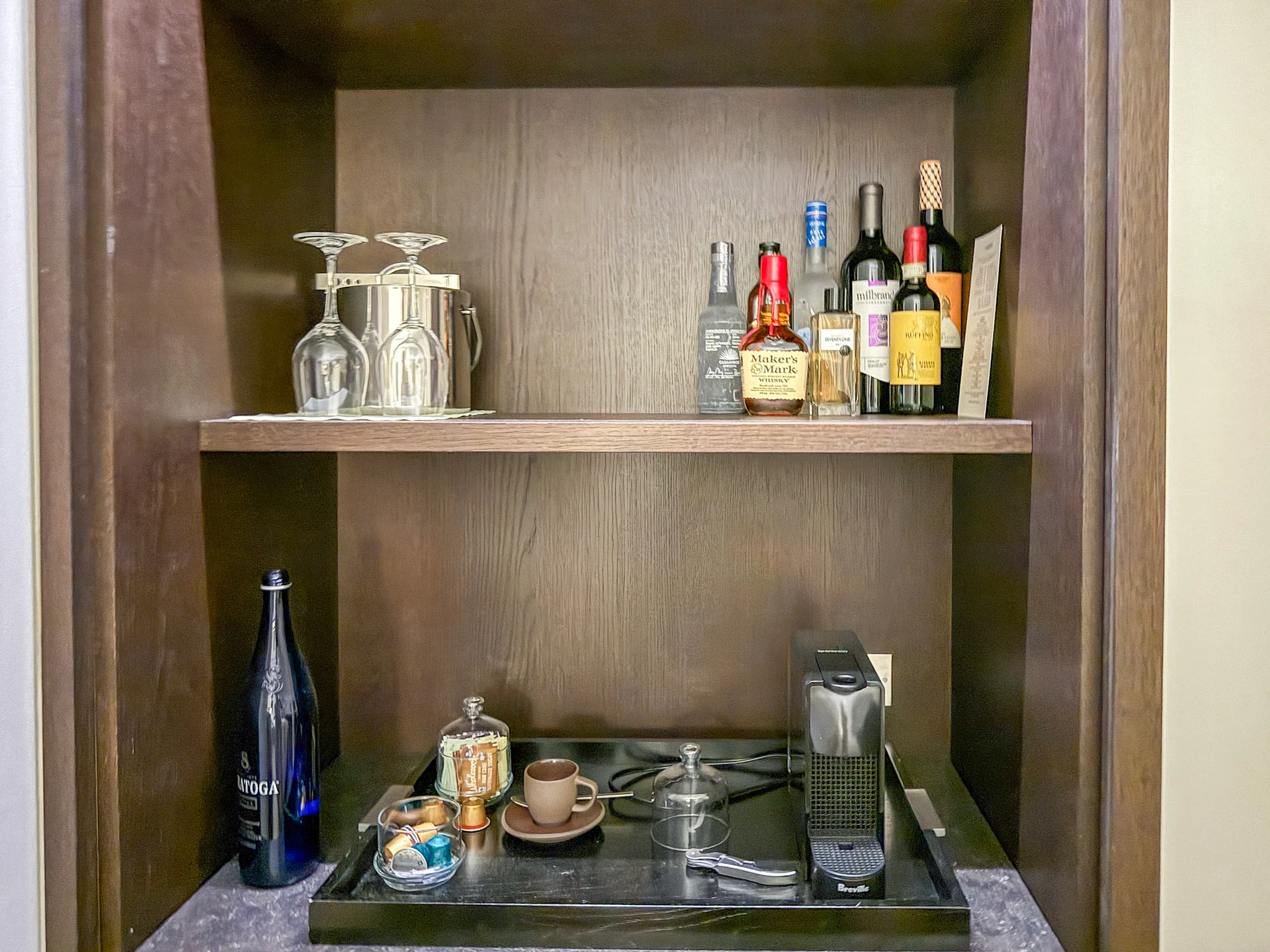 The minibar with (paid) large alcohol bottles and the complimentary Nespresso machine.