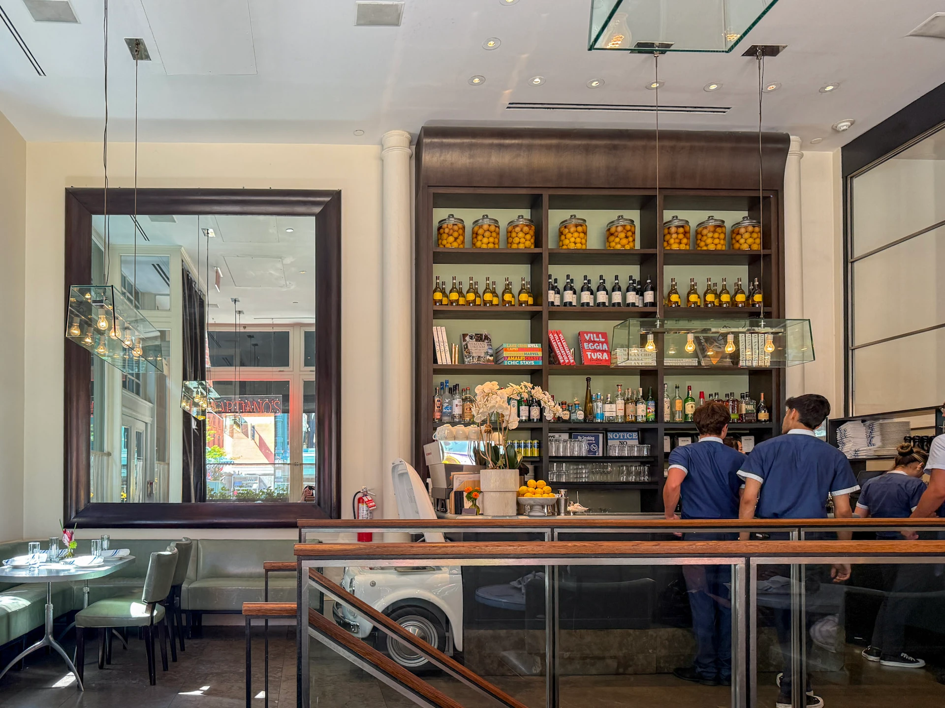 The cheery cafe interior with staff working the bar area.