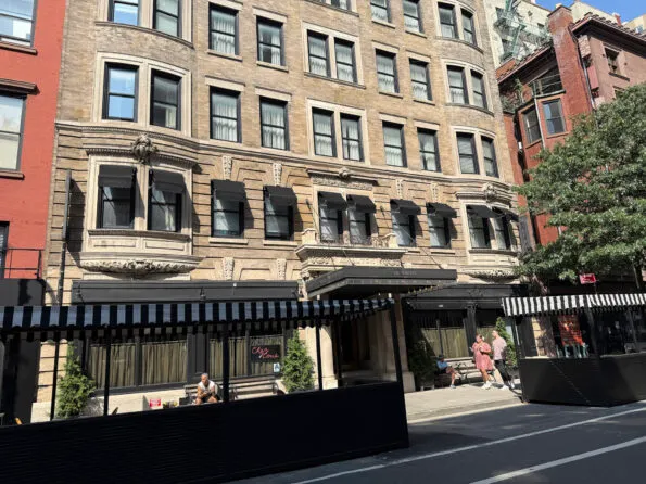The building hotel exterior with outdoor street dining.