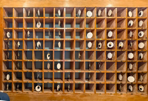 The wooden key cubby behind the front desk.