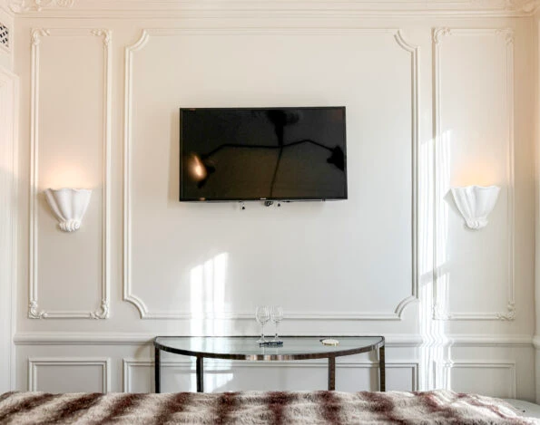 A flat screen TV on the wall of my Deluxe Queen room at The Marlton Hotel NYC.