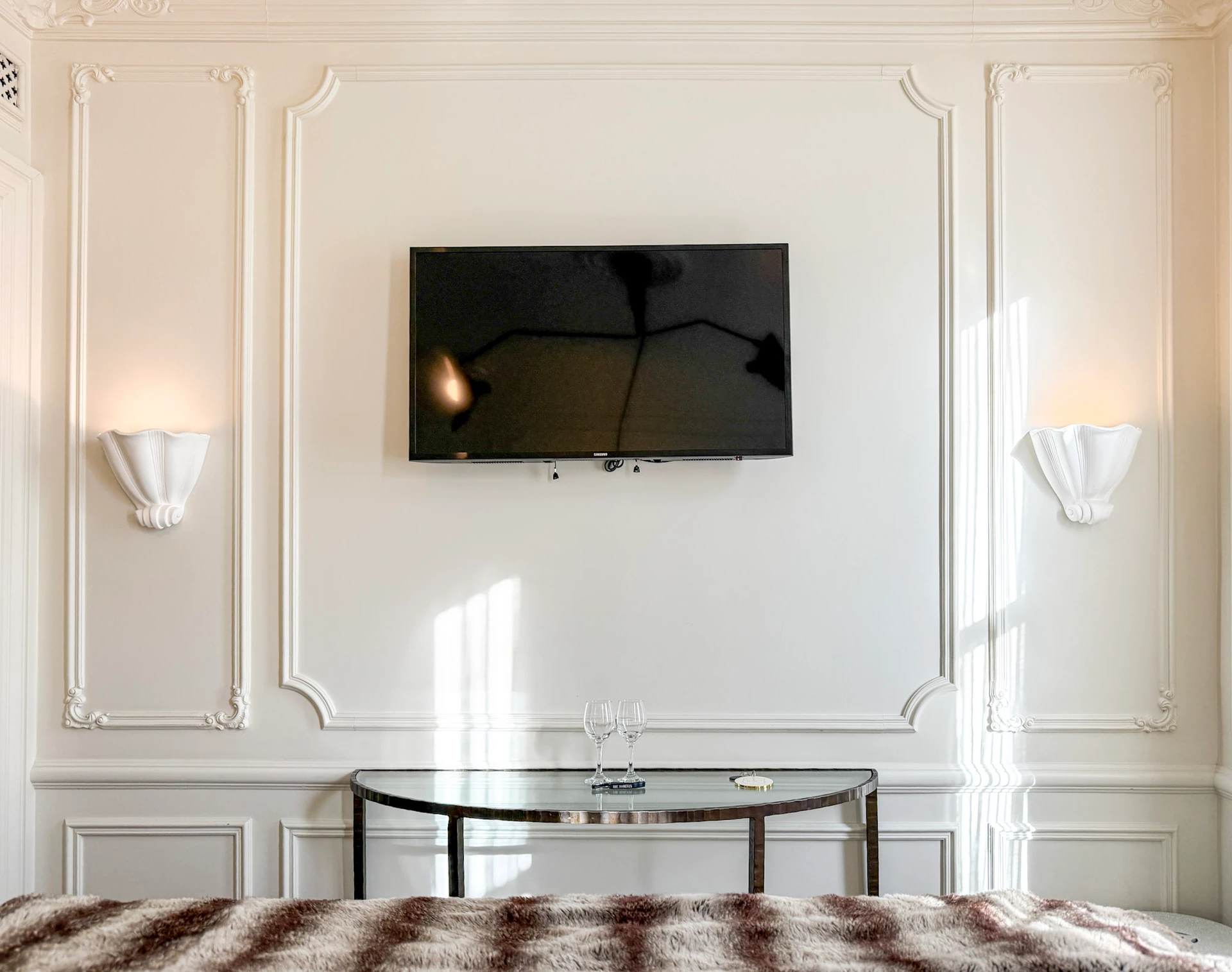 A flat screen TV on the wall of my Deluxe Queen room at The Marlton Hotel NYC.