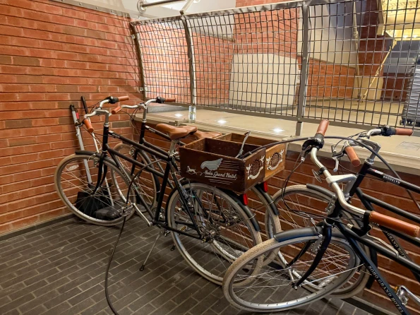 Cool bicycles on ground level with Soho Grand Hotel baskets for guest use.