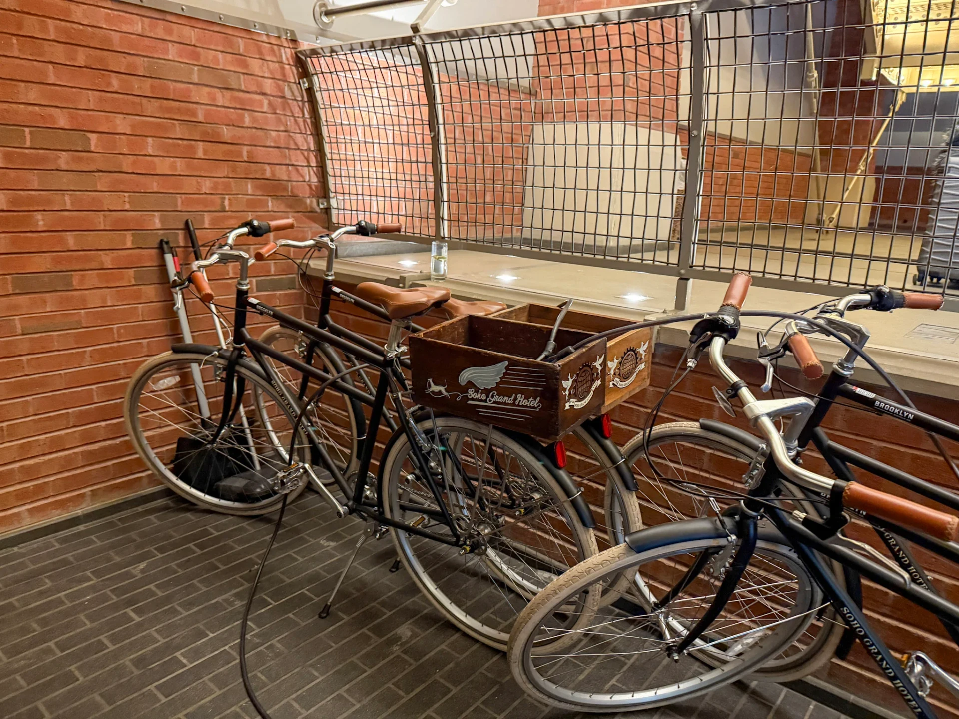 Cool bicycles on ground level with Soho Grand Hotel baskets for guest use.