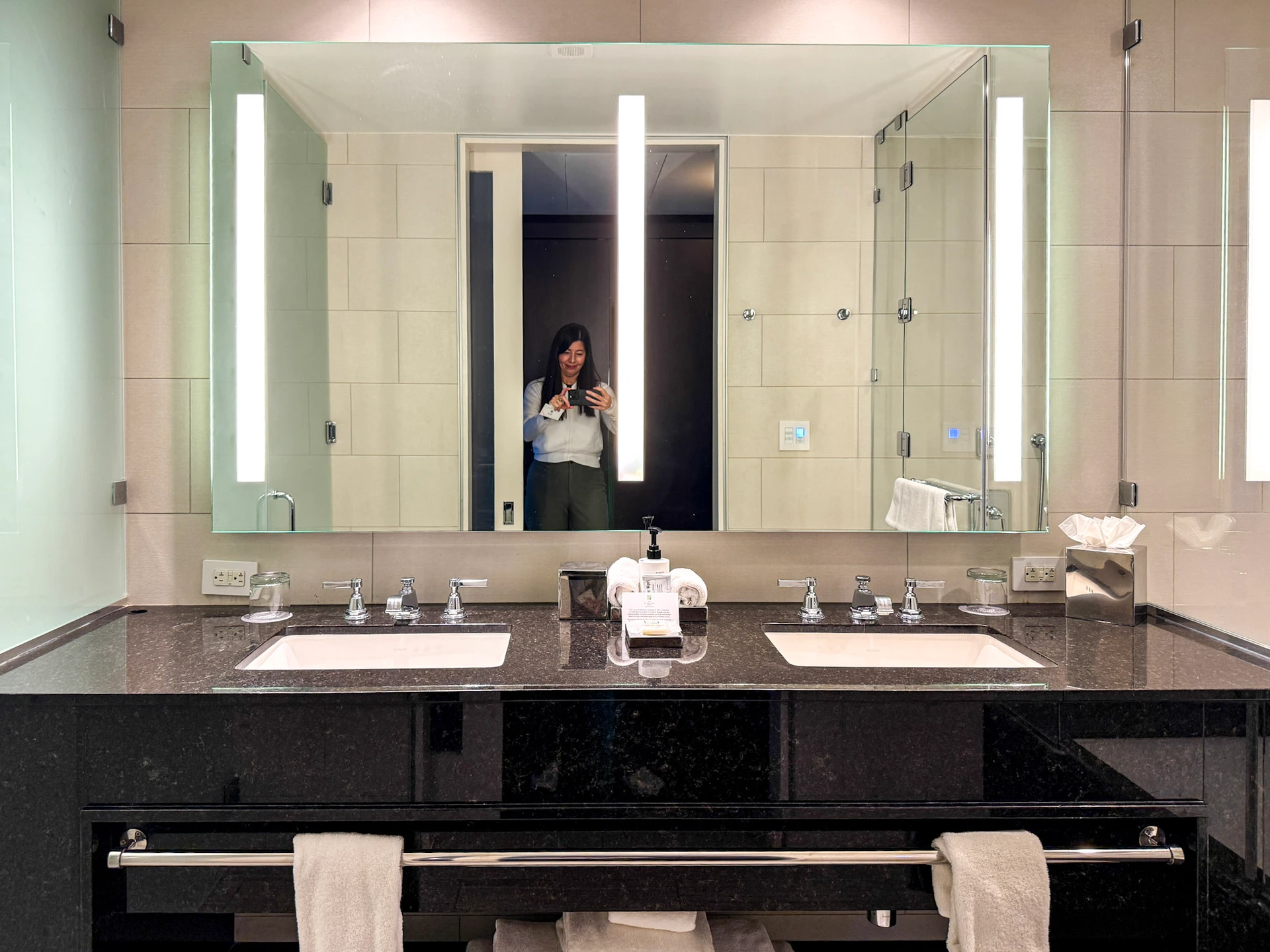 Black marble double sink vanity area.