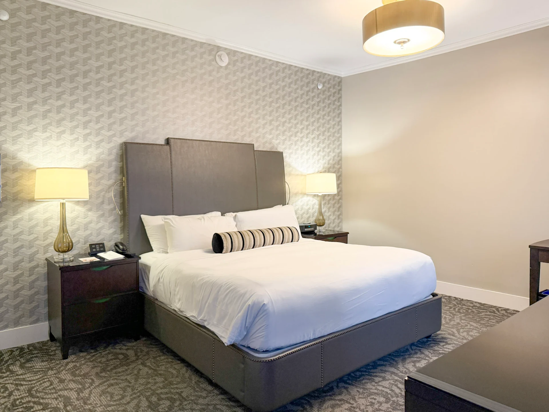 My bed at The St. Anthony with crisp white sheets.