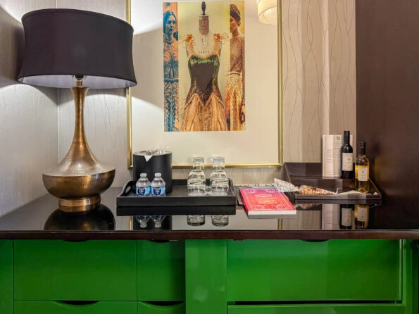 The minibar area on top of a green lacquered chest.
