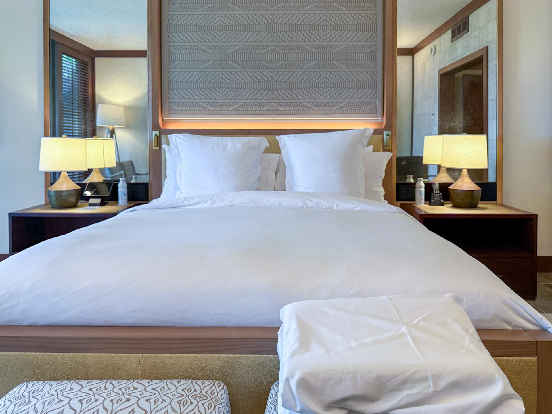 Two orthopedic pillows sit on the bench at the foot of my bed at Four Seasons Hualalai.