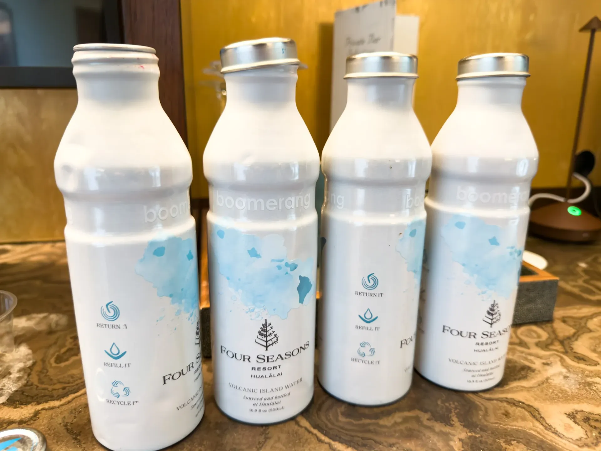 Water in recycled metal bottles on the counter of my room at Four Seasons Hualalai.