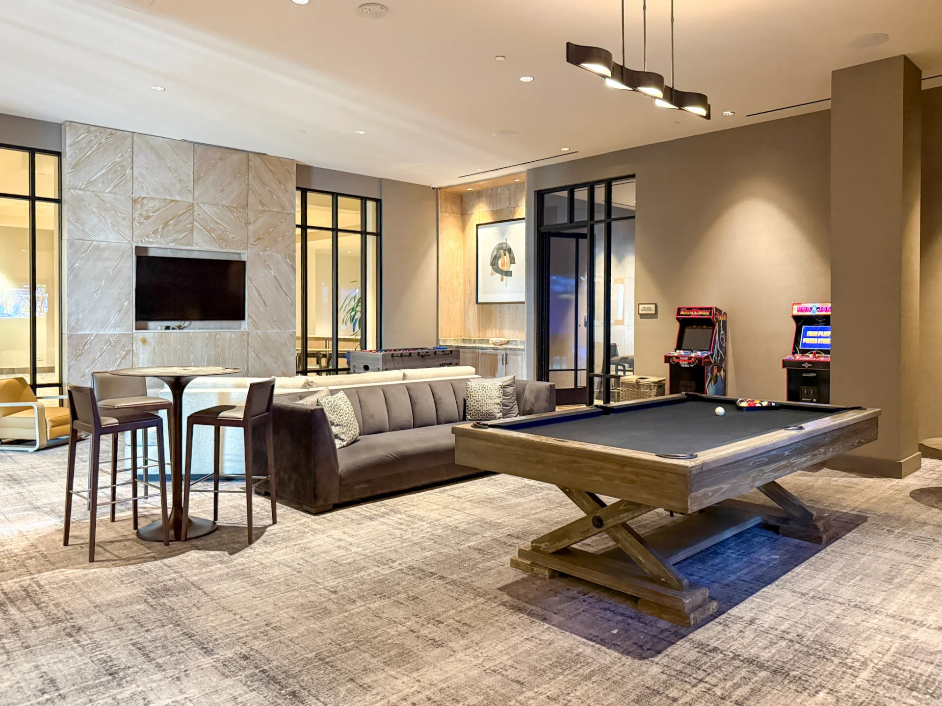 The game room with pool, sofas, arcade games next door to the Top Swing Suite.