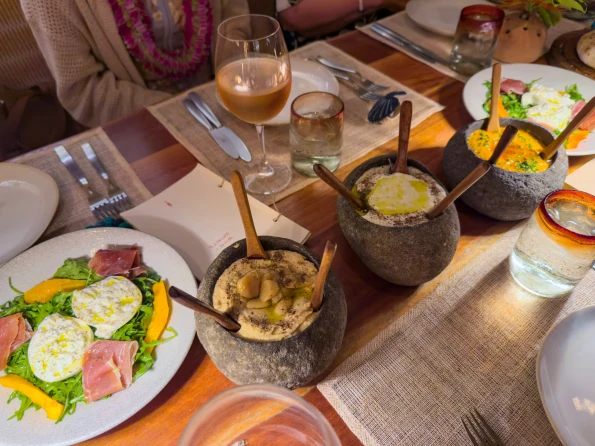 Hummus dips served in coconut bowls on our table as appetizers.