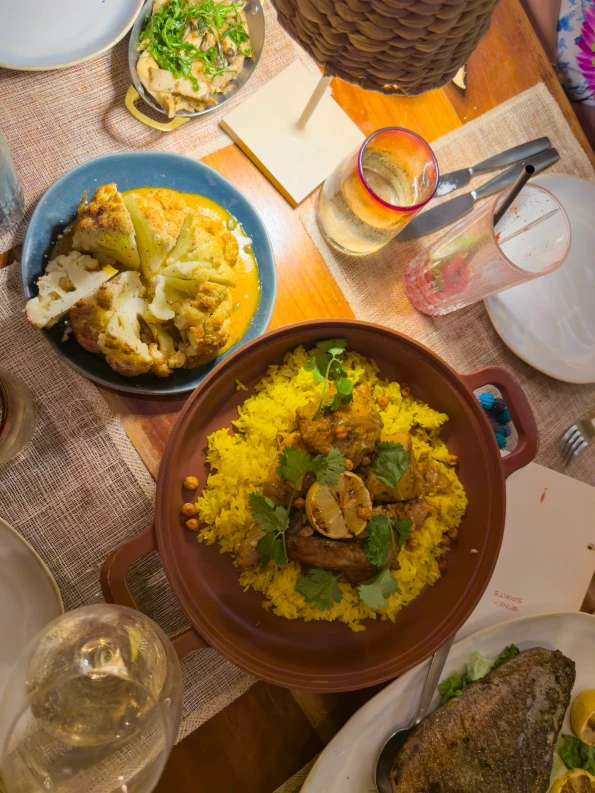 A cauliflower, chicken tagine, and fish entree.