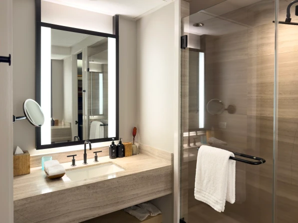 The shower and one of two sinks in view in my bathroom.