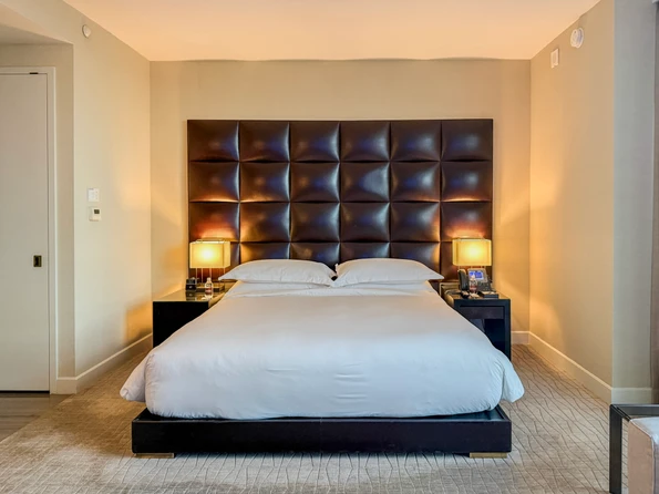 A king size bed in a SoHi room.
