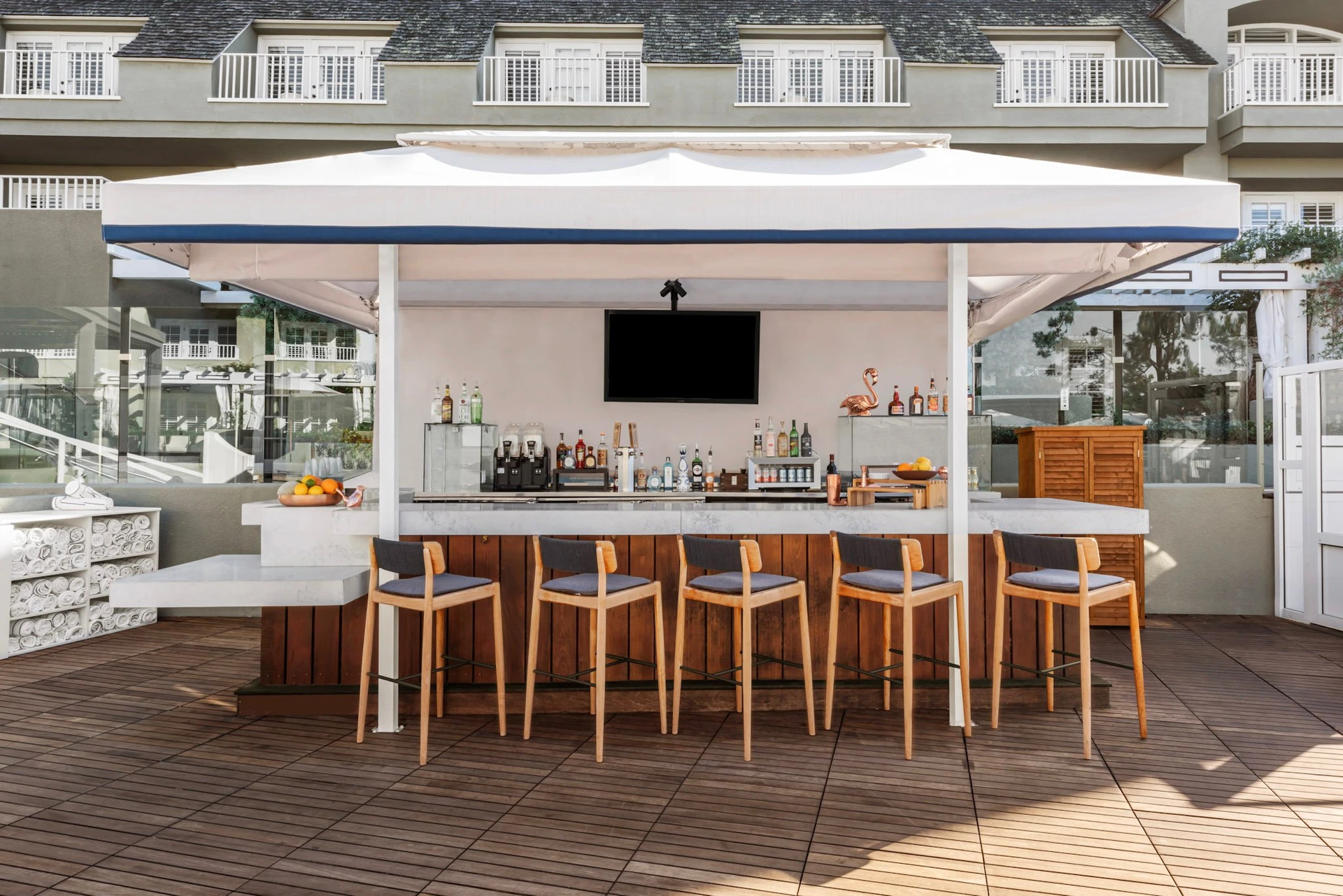 The outdoor covered pool bar with stools waiting for guests.