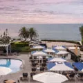View over the L'Auberge Del Mar pool deck to the ocean at sunset.