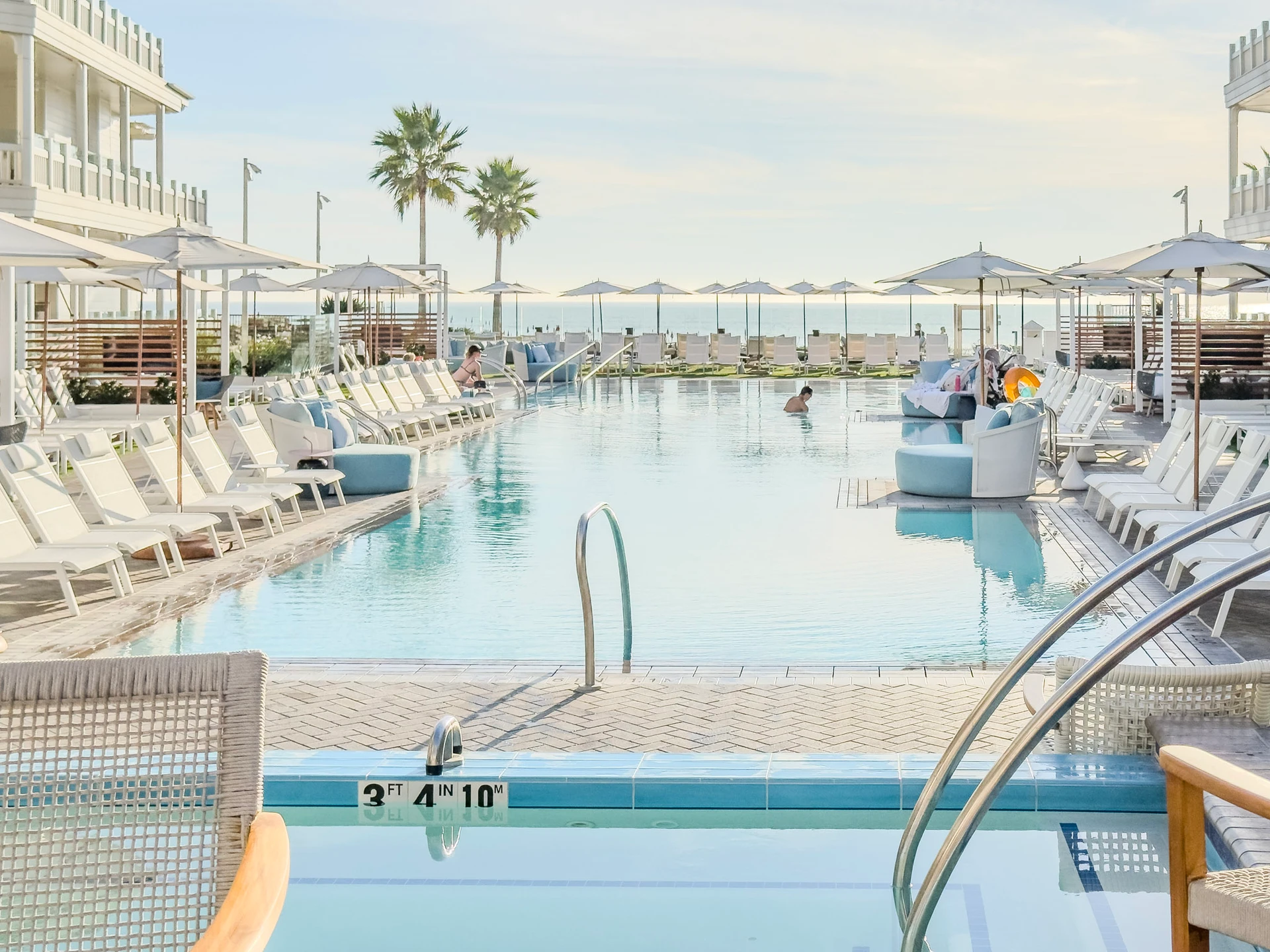 People enjoy the Shore House at The Del swimming pool on a sunny day.