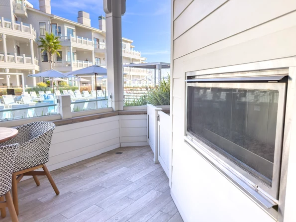 Outdoor fireplace at Shore House at The Del on the patio.