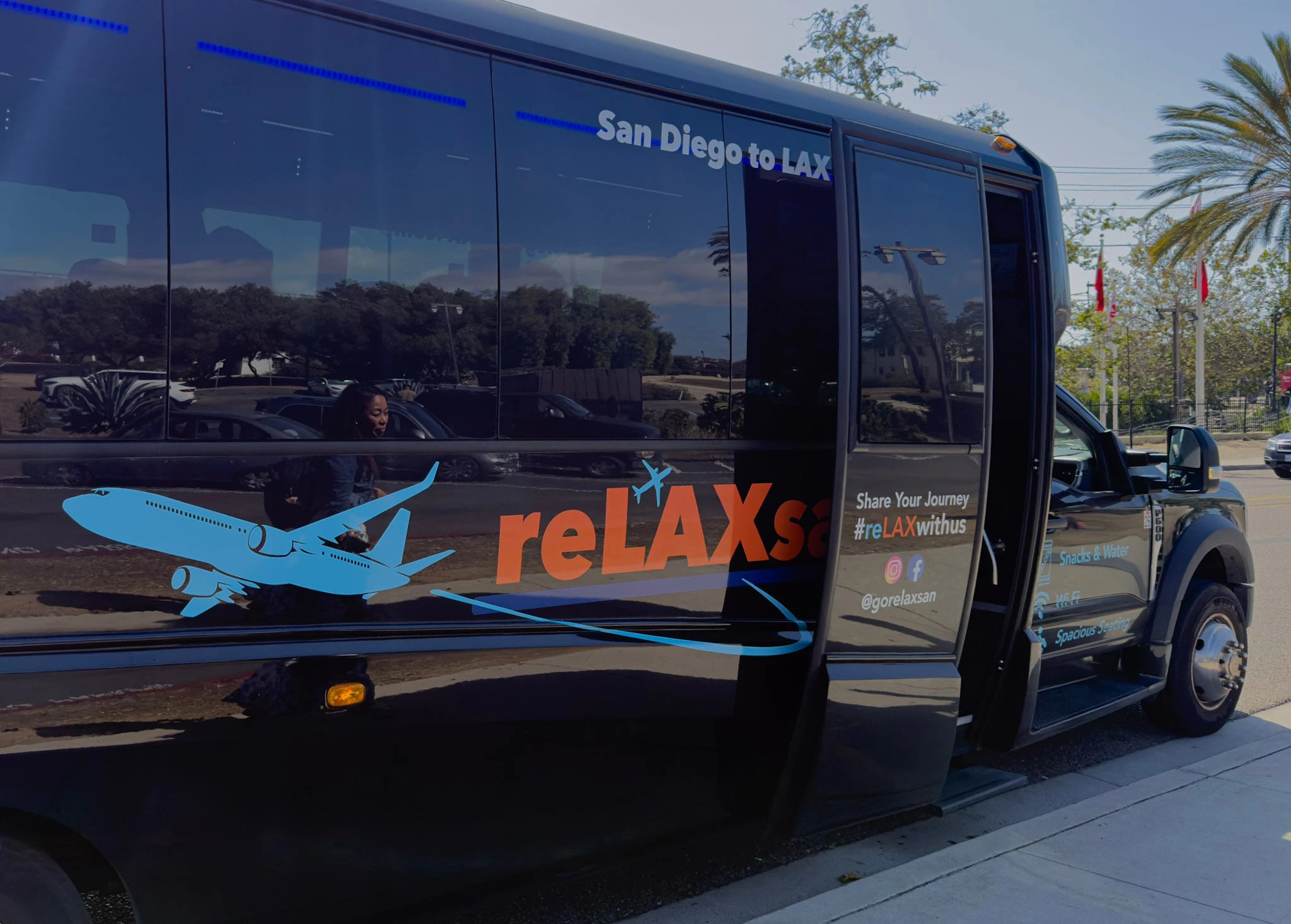The reLAXsan shuttle bus with open door at Old Town.