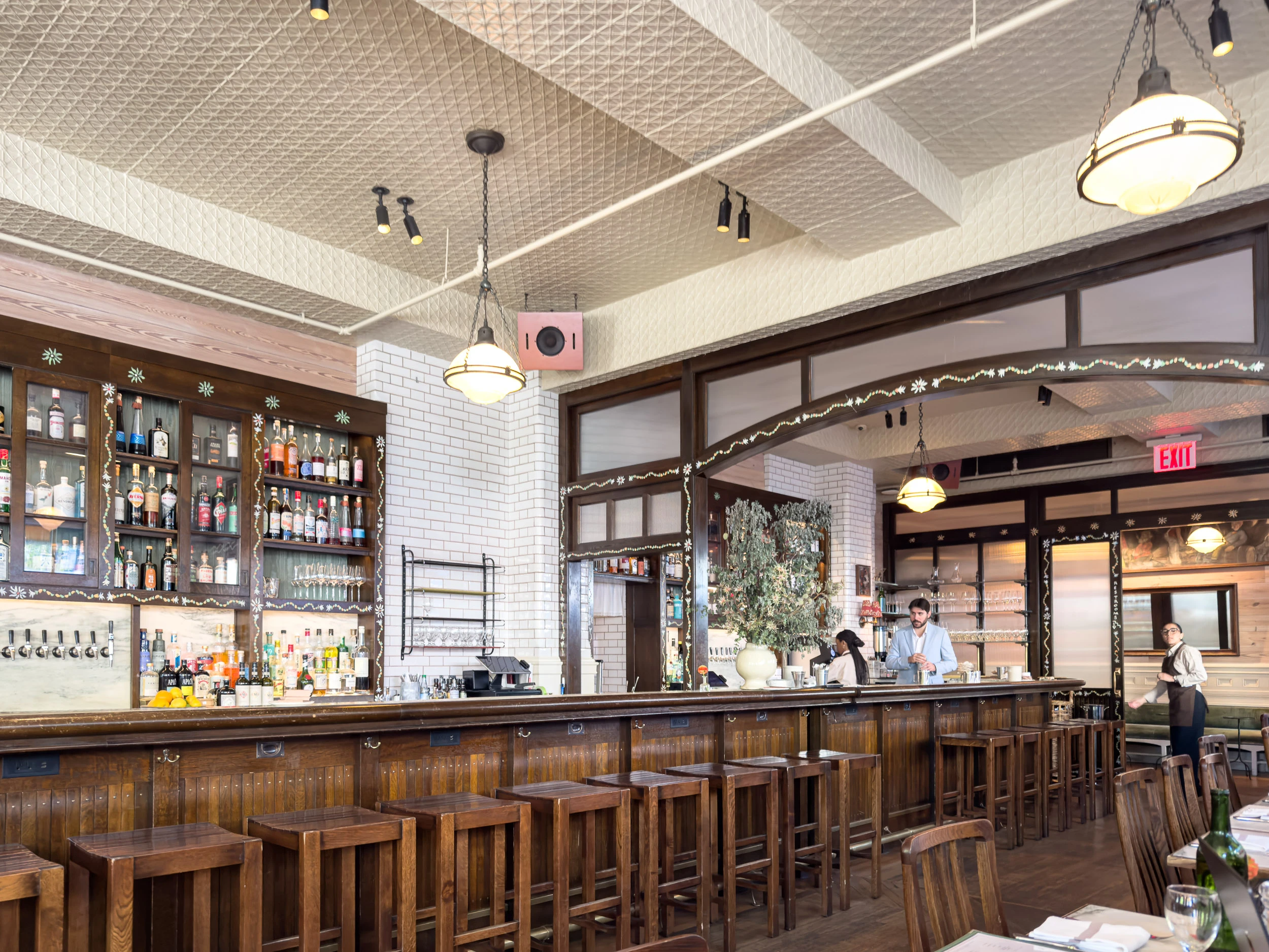 The bar and tiled ceiling at Corner Bar inside Nine Orchard