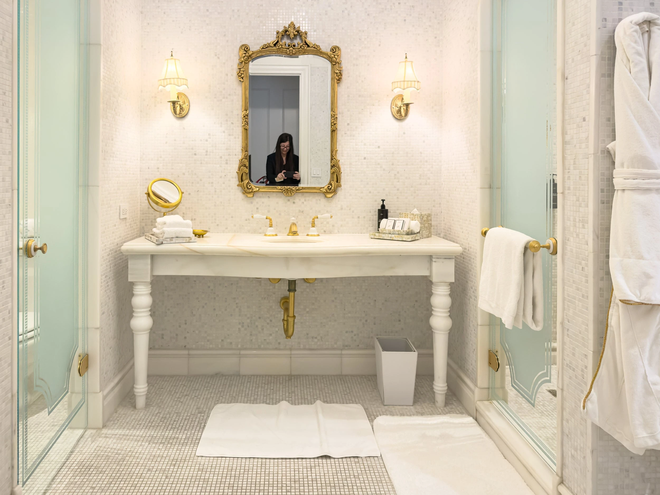 Bathroom vanity with gilt mirror and marble counter at The Plaza Hotel New York