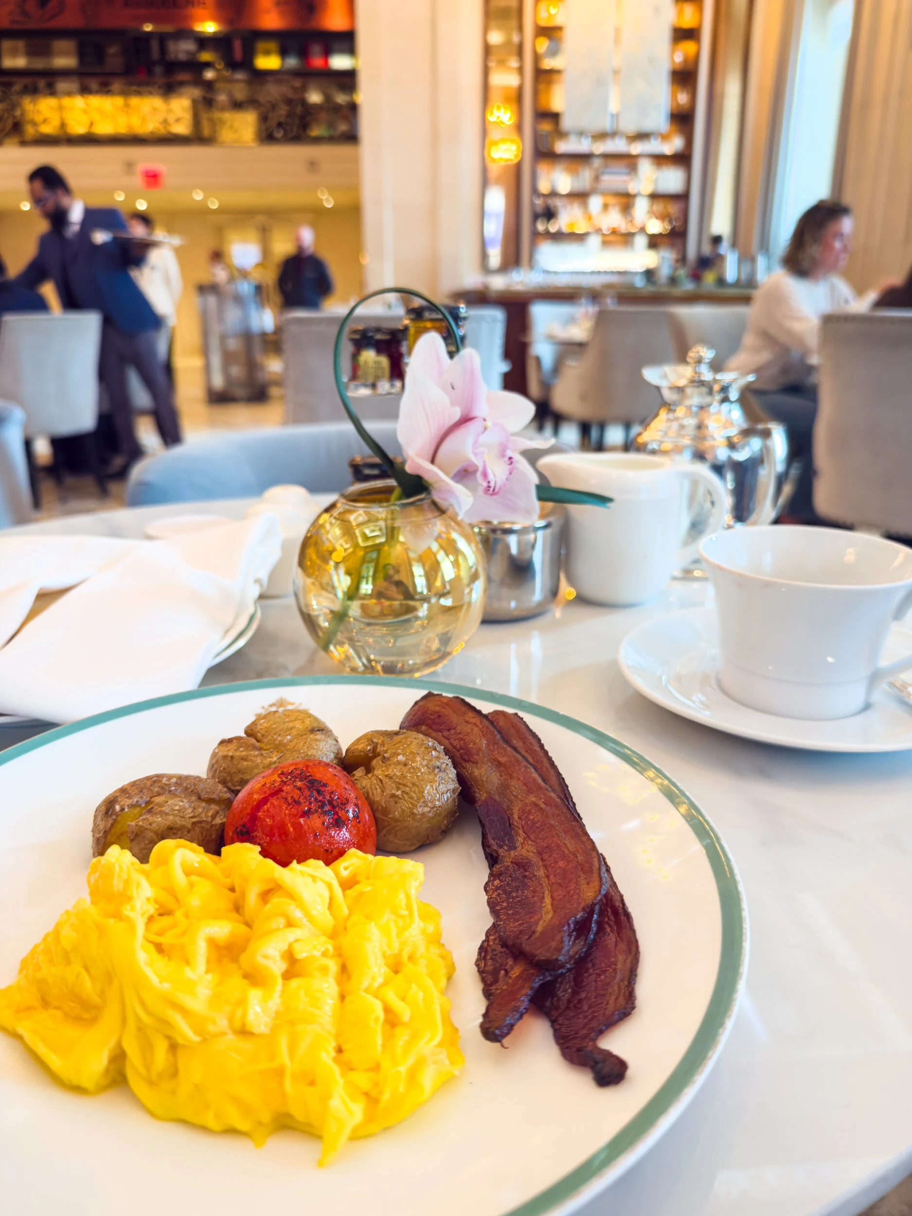 Breakfast of scrambled eggs, bacon and roasted tomatoes at The Plaza Hotel New York