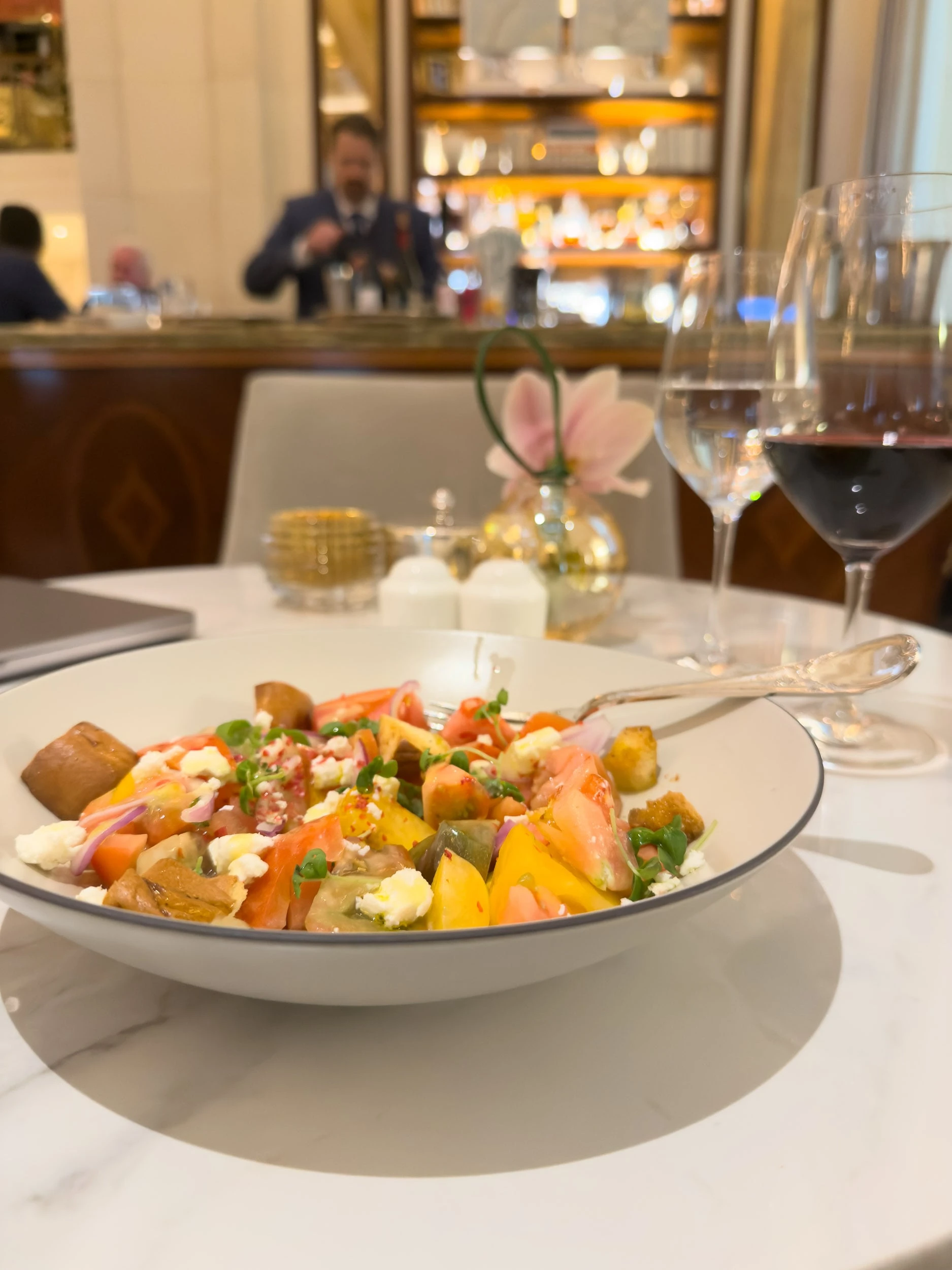 Plated seasonal dish with wine at a restaurant inside The Plaza Hotel New York