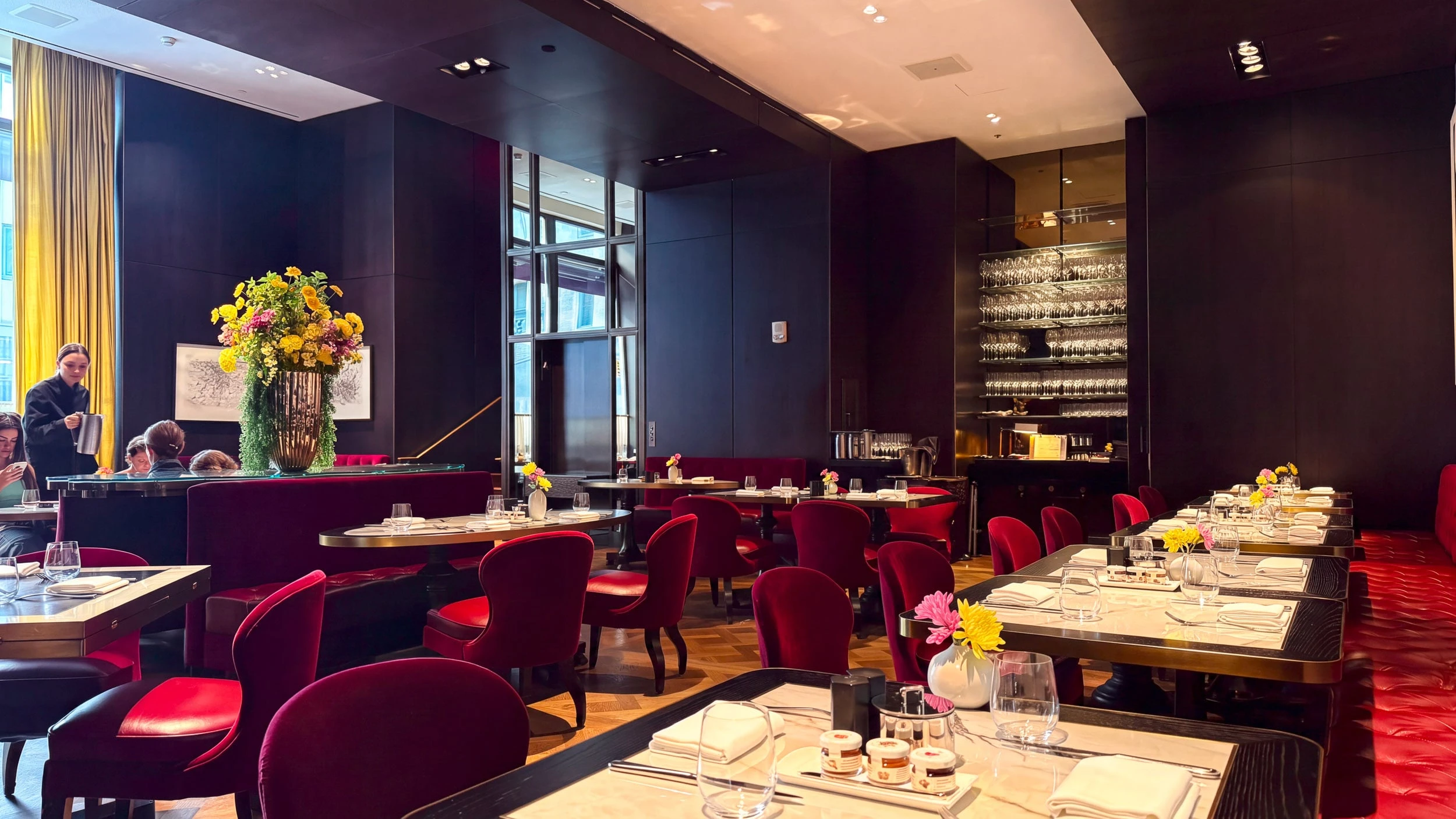 The dining room at CUT by Wolfgang Puck, with red velvet booths.