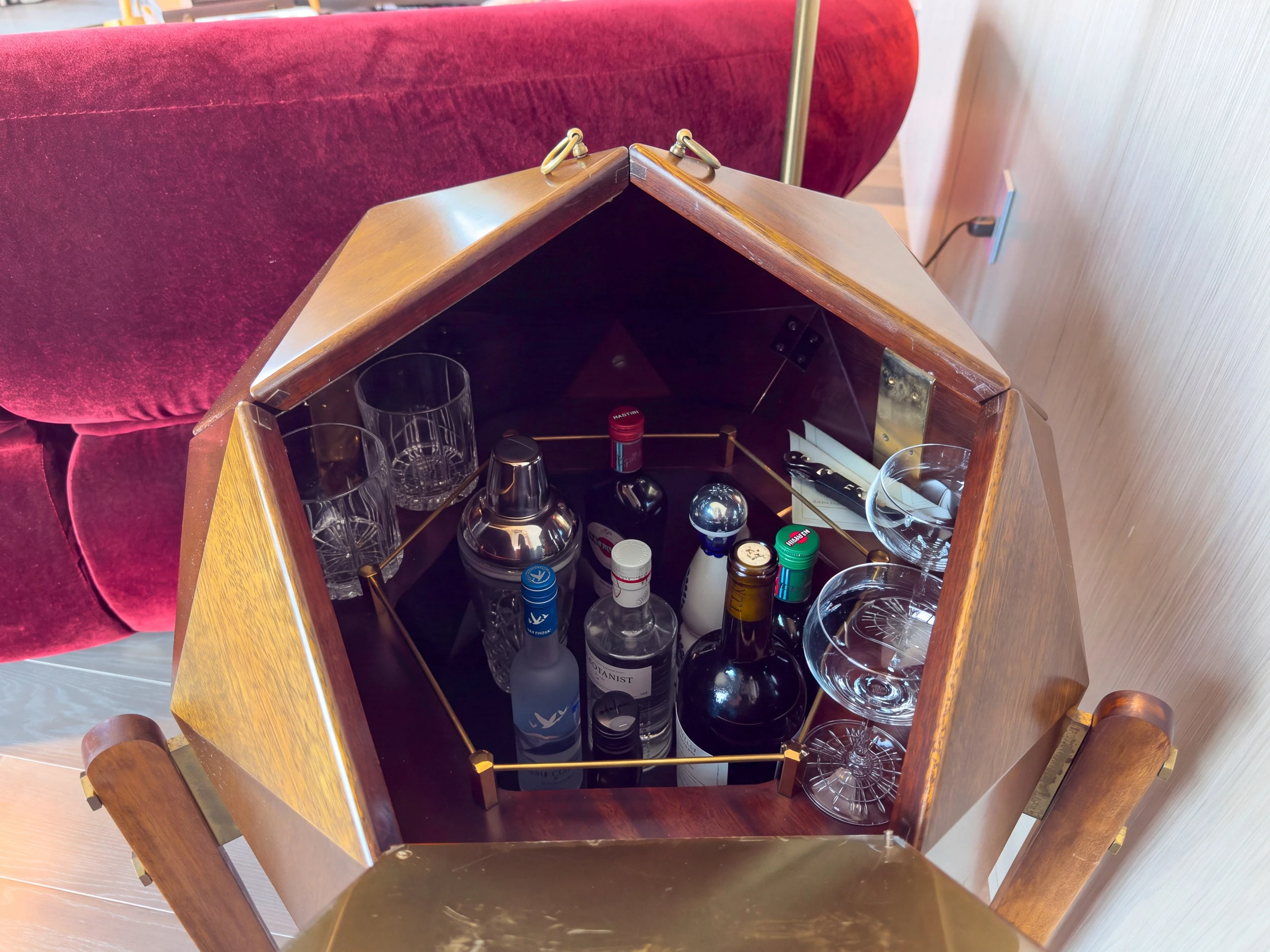 The bar cube in the Tribeca Suite living room, open to show glassware and bottles.