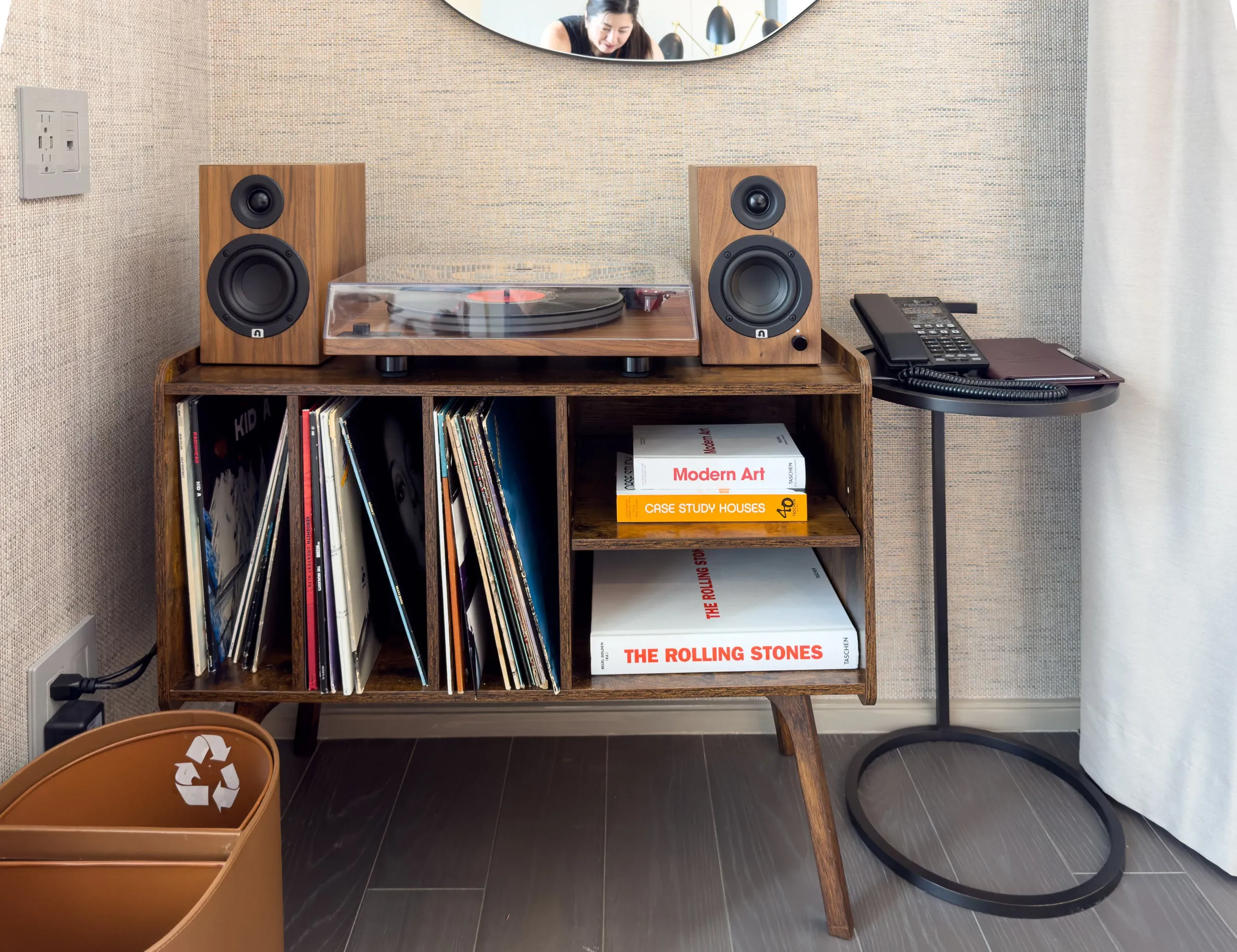 The record player and records in a cabinet.