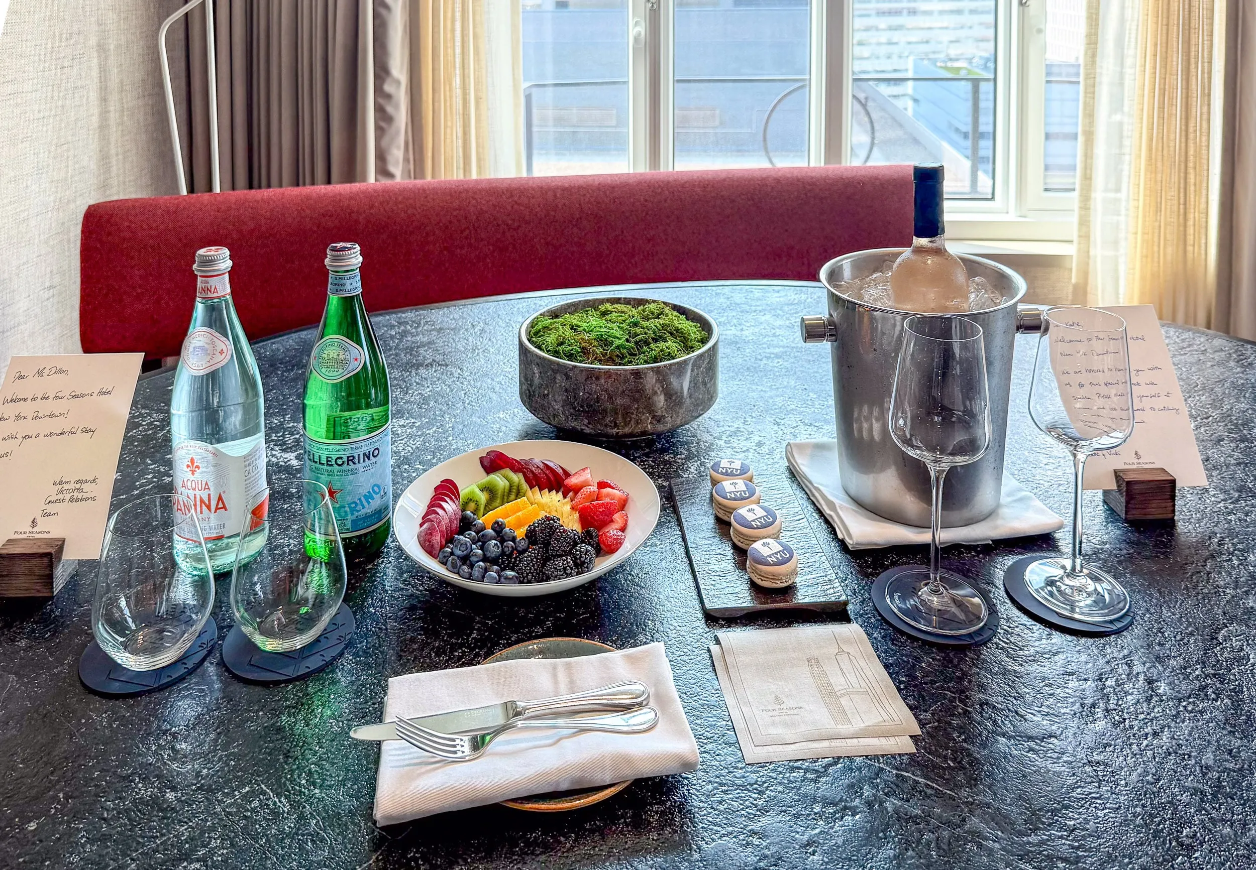 Our NYU macarons, ros&eacute;, fruit, and water welcome amenity.