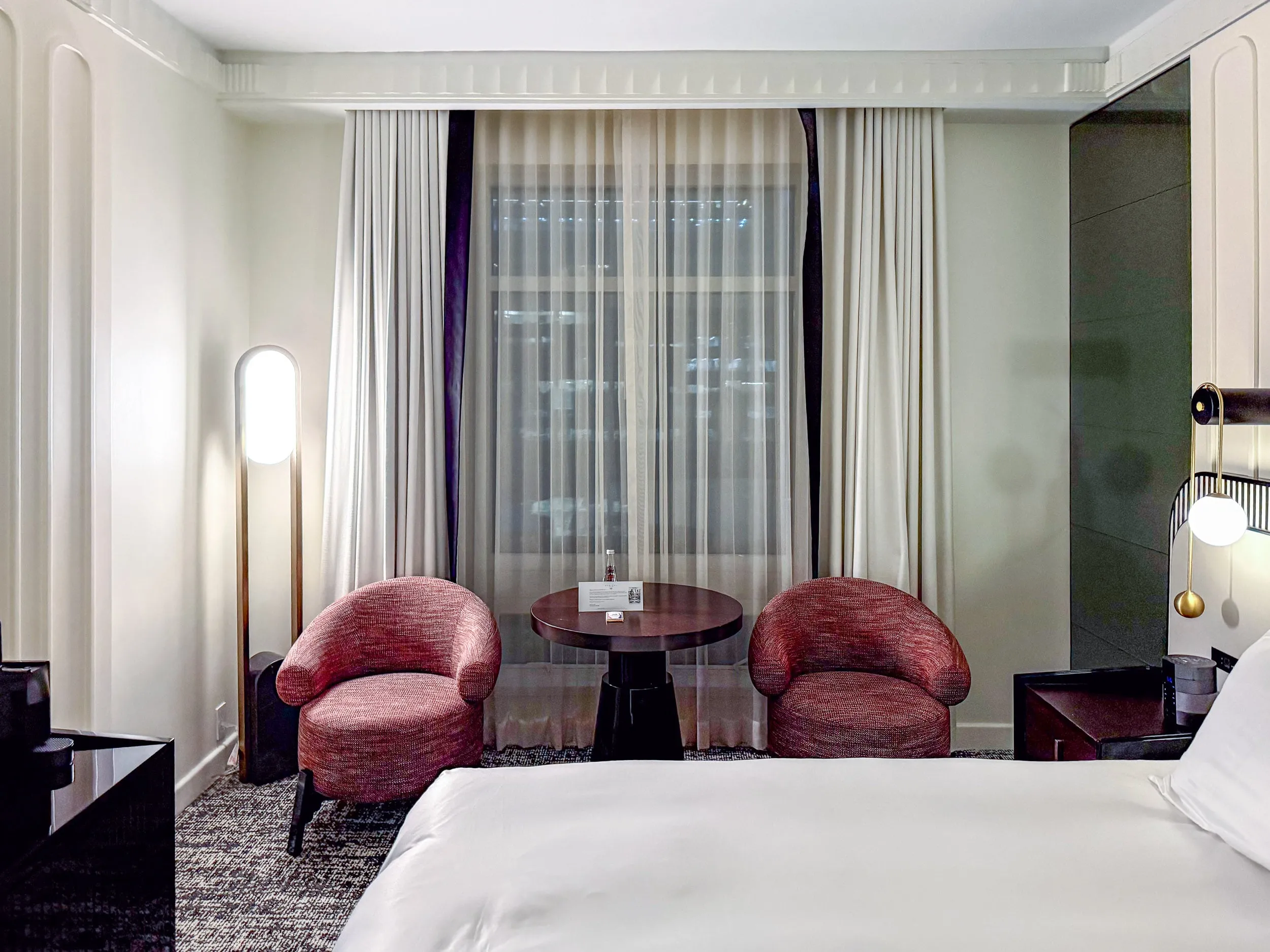 The two club chairs and welcome amenity on the table.