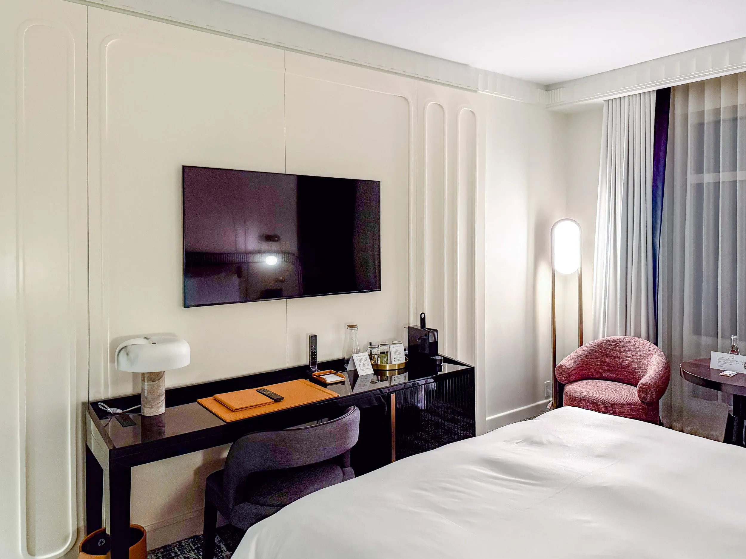 The TV and desk area with coffee maker at Sofitel NYC Midtown.