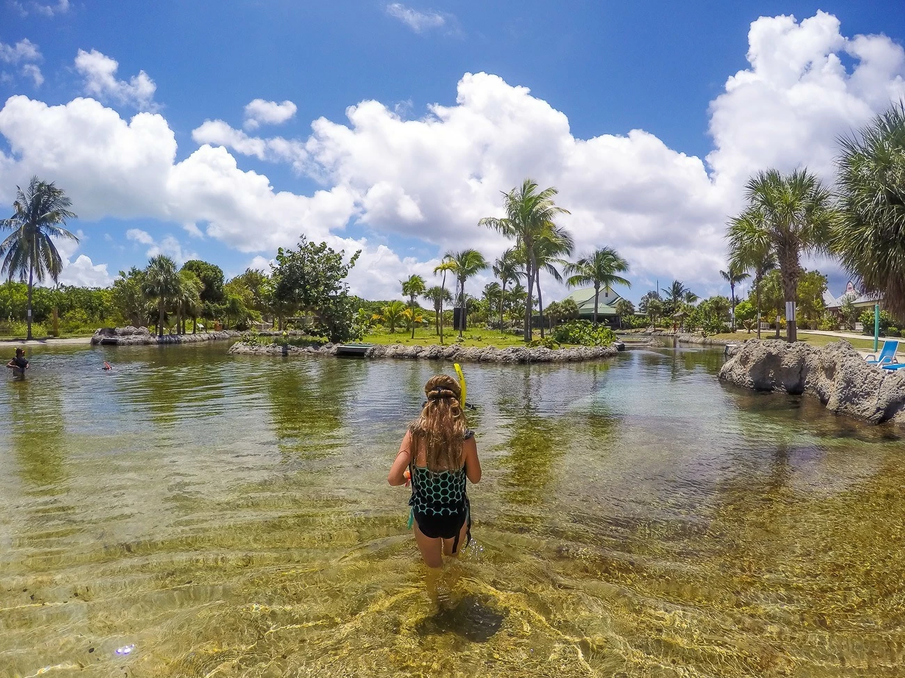 A girl prepares to snorkel in the turtle pool.
