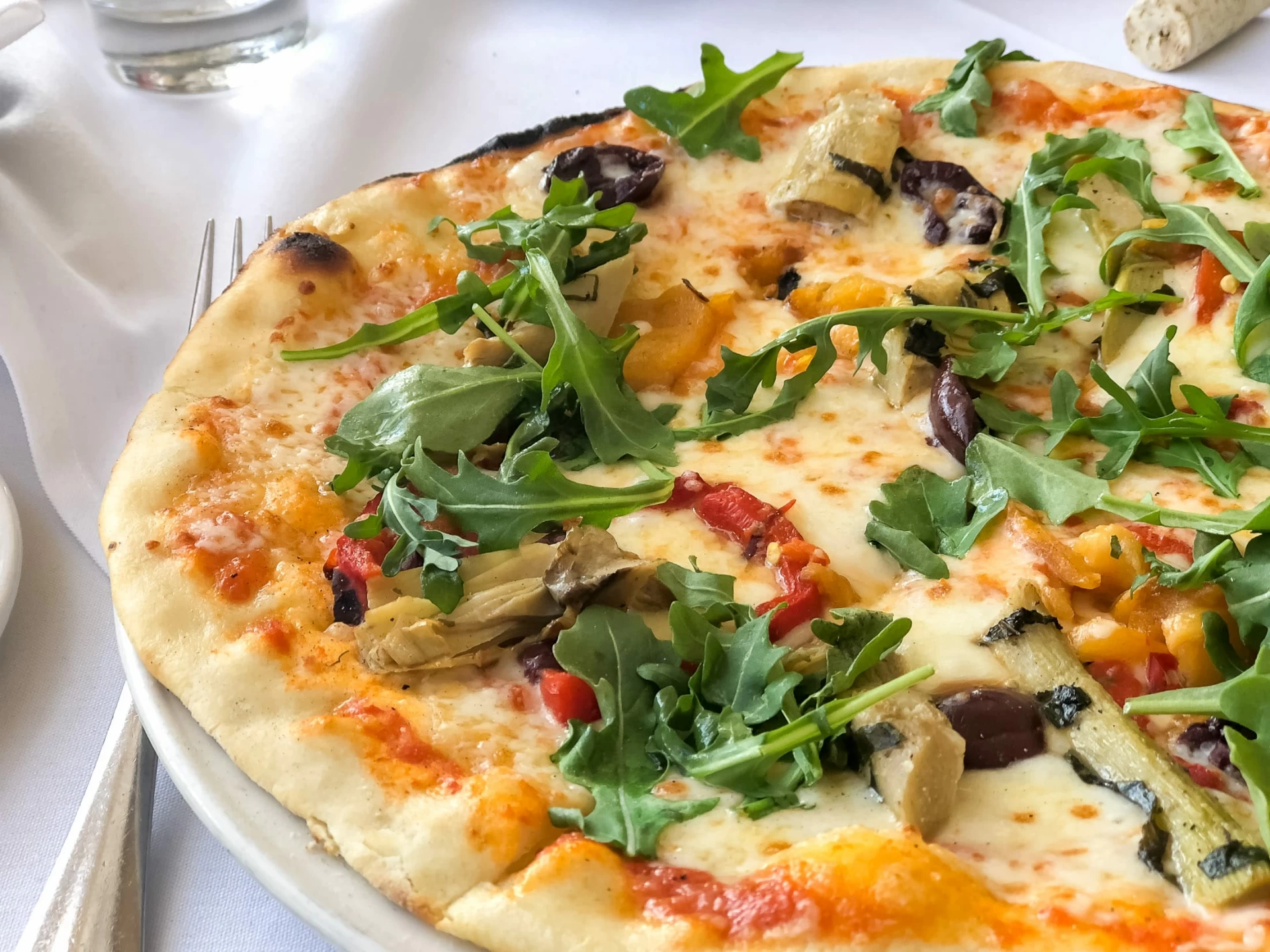 A wood-fired pizza on the table at Piatti, a popular La Jolla Italian restaurant.