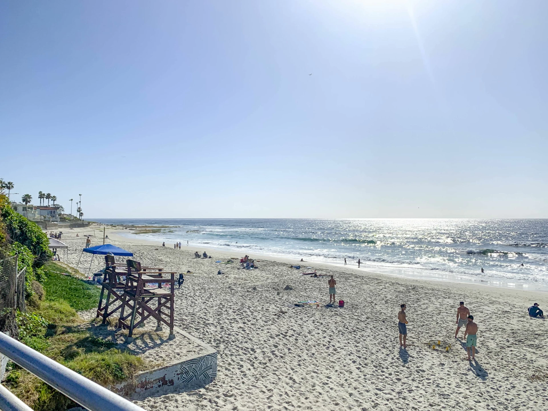 The Marine Street Beach chairs with people playing beach games on the sand in La Jolla, CA.