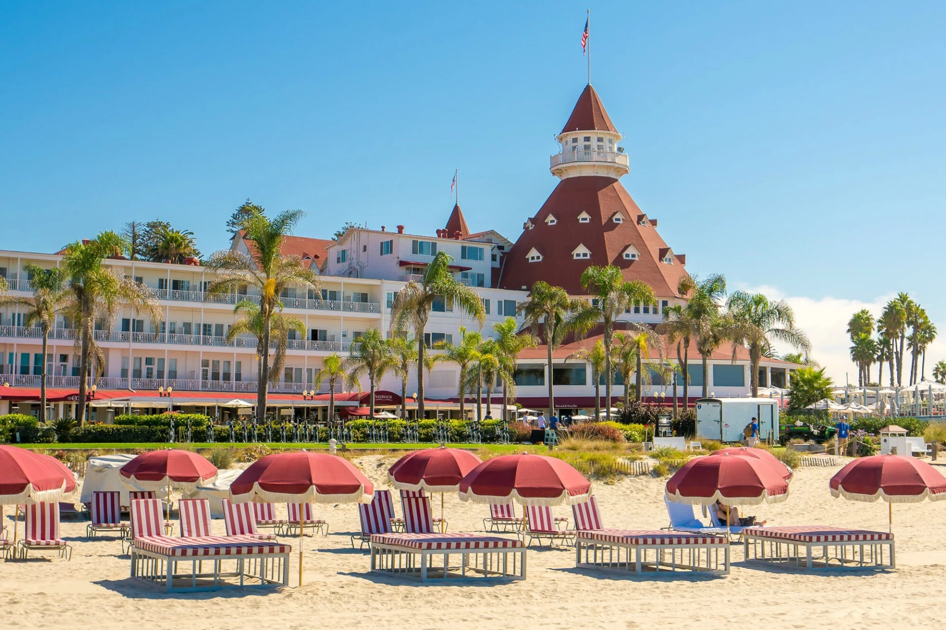 Red and white striped lounge chairs on the beach in front of Hotel Del Coronado.