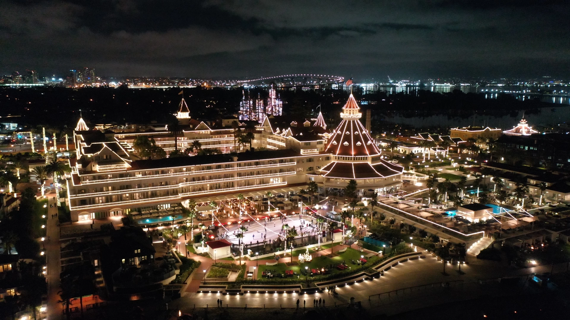 Aerial view of Hotel del Coronado resort during the holiday season at night.